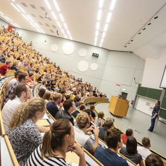 Studierende sitzen in einer Vorlesung im Hörsaal. 